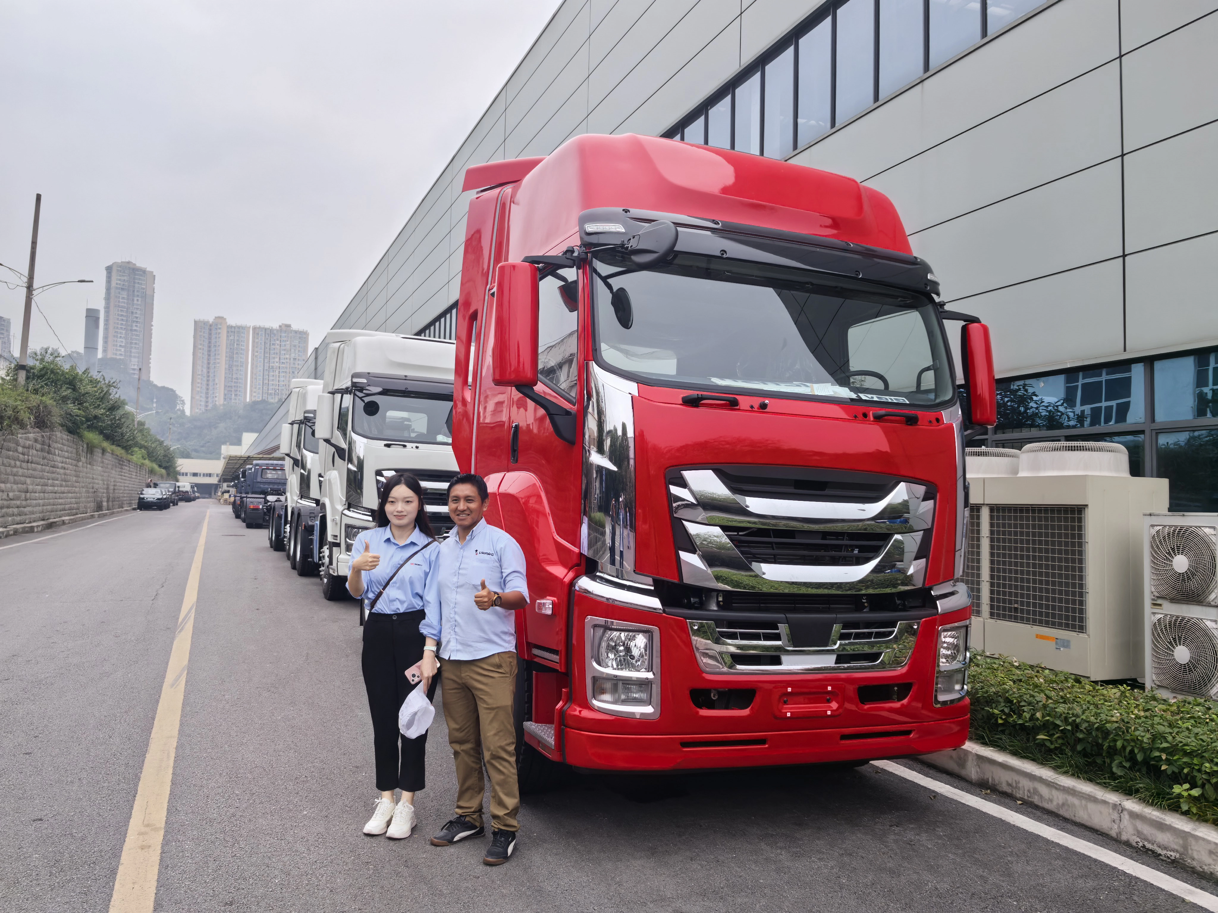 Peruvian client inspecting Isuzu commercial trucks during factory visit