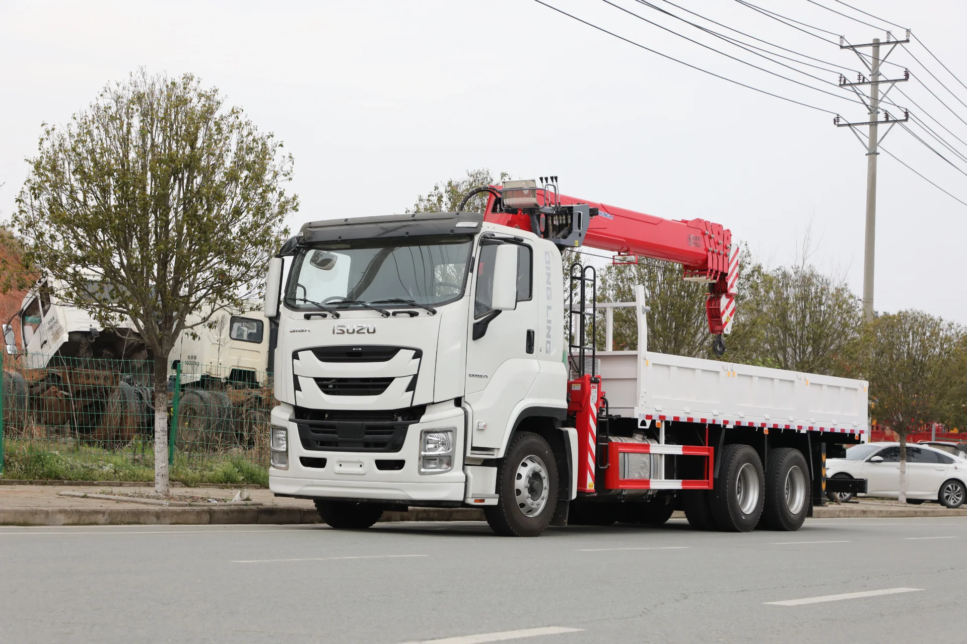 Isuzu truck mounted crane working on a construction site with multi-ton lifting capacity